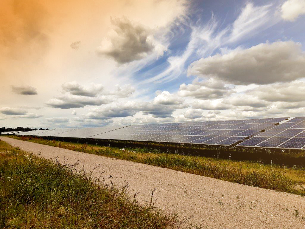 Solar park under a dramatic cloudy sky